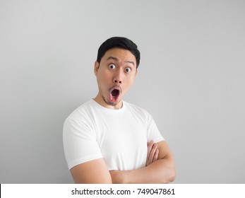 Shocked Face Of Asian Man In White Shirt On Grey Background.