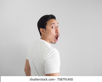 Shocked Face Of Asian Man In White Shirt On Grey Background. Turn Around.