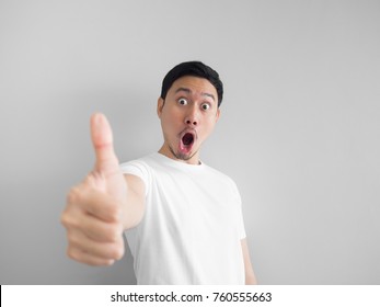 Shocked Face Of Asian Man In White Shirt On Grey Background.