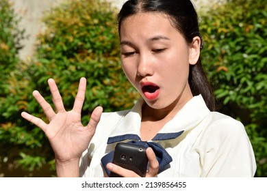 Shocked Filipina Adult Female With Mobile Phone