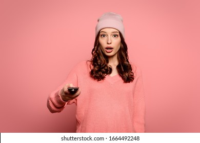 Shocked Girl Holding Tv Remote Controller On Pink Background