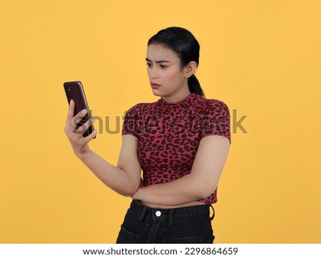 Shocked Girl Looking at Phone - Face Expression by Indian Girl Depicting mild shock