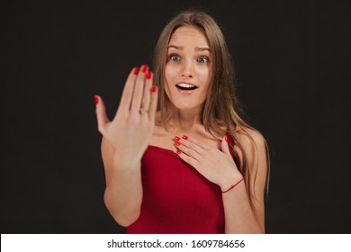 Shocked Girl Showing Proposal Ring On Her Hand Wearing Dress On Grey Background