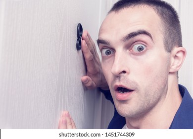 Shocked Guy Next To Front Door, Man Looked Through The Peephole Of The Front Door, Portrait, Close Up, Toned