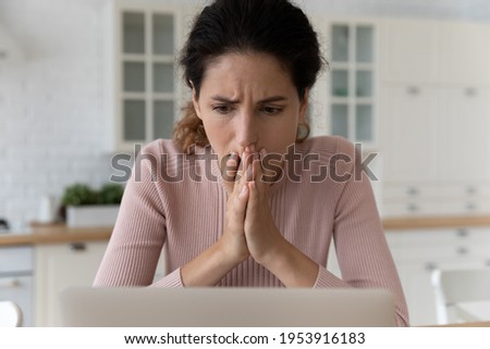 Shocked hispanic female read unexpected bad news on pc screen feel panic anxiety. Scared young latina woman overwhelmed with blackmail scam message stack palms by face pray to see way out of problem [[stock_photo]] © 