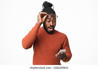 Shocked impressed african-american young man winning money on bet in online casino, reading news on cellphone smart phone isolated in white background - Powered by Shutterstock