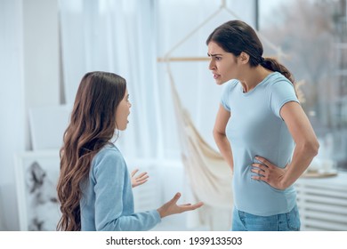 Shocked Indignant Mom Standing In Front Of Stubborn Daughter