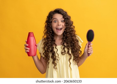 Shocked Kid Curly Hair Hold Comb And Shampoo Bottle. Teen Beauty Hairstyle.