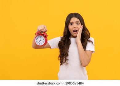shocked kid hold retro alarm clock showing time, delay