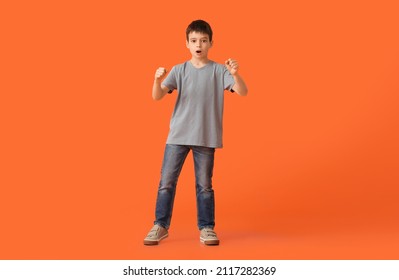 Shocked little boy with imaginary steering wheel on color background - Shutterstock ID 2117282369