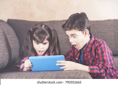 Shocked Little Kids React While Watching Inappropriate Content On Their Tablet. Internet Safety For Kids Concept.