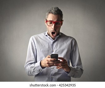 Shocked Man Checking His Phone