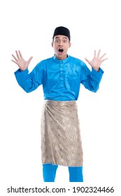 shocked man looking at camera over white background. male with satin melayu clothes