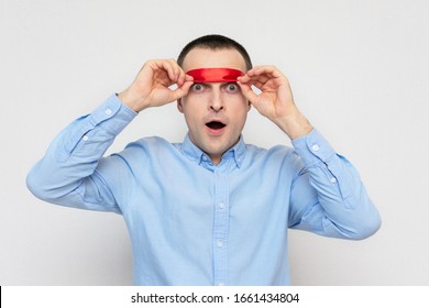 Shocked Man Removes Red Blindfold, Portrait, White Background