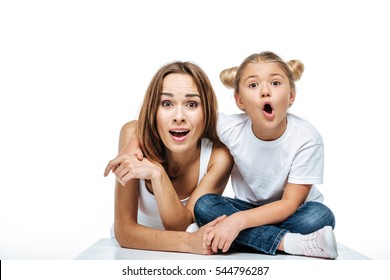 Shocked Mother And Daughter Looking At Camera Isolated On White