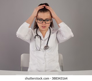 Shocked Nurse With Lots Of Work At The Table