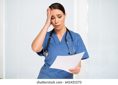 Shocked Nurse Reading A Document