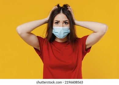 Shocked Panicked Young Brunette Woman 20s Wears Basic Red T-shirt Sterile Face Mask Ppe To Safe From Virus Covid-19 Flu On Lockdown Hold Head With Hands Isolated On Yellow Background Studio Portrait