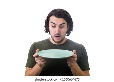 Shocked person holding an empty dish plate in his hands, looking astonished isolated on white background. People has no food to eat after drought. Global crisis and hunger issue. Famine and starvation