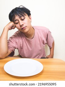 Shocked Person Holding An Empty Dish Plate In His Hands, Looking Astonished Isolated On White Background. People Has No Food To Eat After Drought. Global Crisis And Hunger Issue. Famine And Starvation