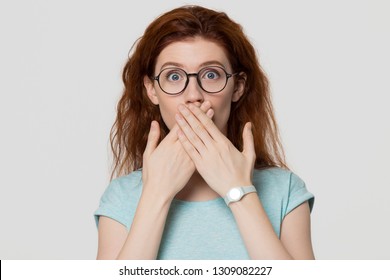 Shocked Red-headed Woman Looking At Camera Covering Mouth With Hands Feel Scared Horrified, Stunned Young Redhead Mute Girl With Surprised Face Astonished Isolated On White Grey Studio Background