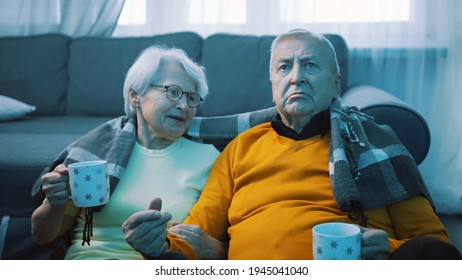 Shocked Retired Couple Watching Tv. Bad News. High Quality Photo