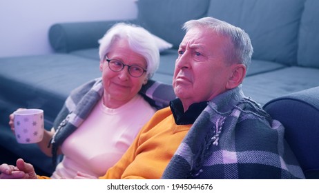 Shocked Retired Couple Watching Tv. Bad News. High Quality Photo