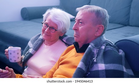 Shocked Retired Couple Watching Tv. Bad News. High Quality Photo