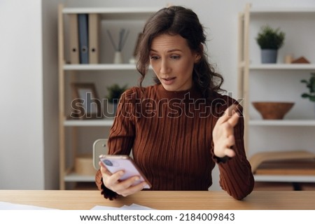 Shocked scandalize irritated angry curly pretty woman quarrel with boyfriend in chat messages suffering from bad relationship break up divorce holds phone raise hand up. People emotions concept