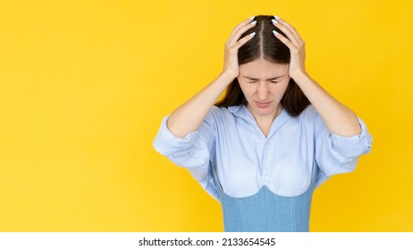 Shocked situation. Desperate woman. Headache suffer. Overload lady grasping head with hands isolated yellow copy space.