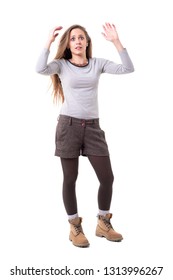 Shocked Startled Young Pretty Expressive Hipster Woman Looking Up With Arms Raised Up. Full Body Isolated On White Background. 