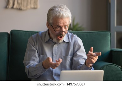 Shocked Stressed Senior Mature Man Looking At Laptop Reading Unbelievable Online News At Home, Crazy Senior Old Grandpa Feel Bad Surprise With Unexpected Computer Problem, Frustrated By System Virus