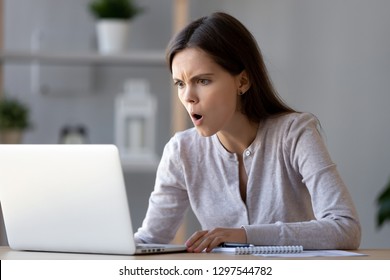 Shocked stressed woman looking at laptop angry reading negative surprise in online news, astonished teen girl flabbergasted with stuck computer problem scam, shocking internet content in social media