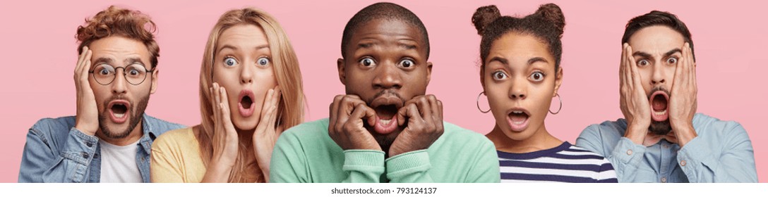 Shocked Stupefied Dark Skinned Man And Their Companions Pose Against Pink Background. Emotional Surprised Horrified Mixed Race People See Something Unexpected In Front. Human Reaction Concept