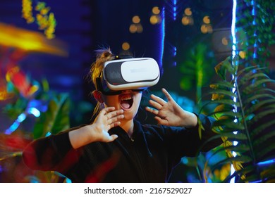 Shocked Stylish Child In Metaverse In Vr Headset.