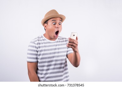 Shocked And Surprised Asian Man Looking Smartphone