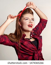 Shocked And Surprised Attractive Girl Smiling Looking To The Side Presenting Your Product . Curly Hair Woman Amazed .Beautiful Girl With Red Candy. Expressive Facial Expressions ,red Lips.Pin Up