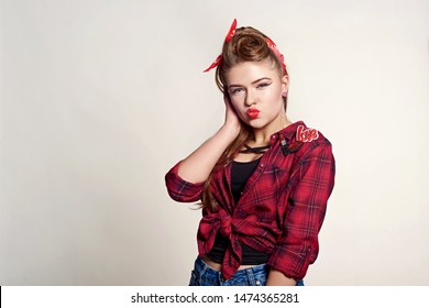 Shocked And Surprised Attractive Girl Smiling Looking To The Side Presenting Your Product . Curly Hair Woman Amazed .Beautiful Girl With Red Candy. Expressive Facial Expressions ,red Lips.Pin Up