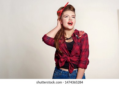 Shocked And Surprised Attractive Girl Smiling Looking To The Side Presenting Your Product . Curly Hair Woman Amazed .Beautiful Girl With Red Candy. Expressive Facial Expressions ,red Lips.Pin Up