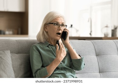 Shocked surprised blonde senior woman excited with telephone call talking on cellphone, speaking emotionally, listening with open mouth, getting awesome news from conversation - Powered by Shutterstock