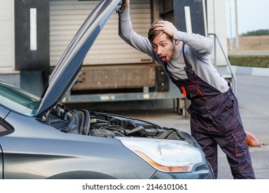 Shocked Technician Mechanic Looks Inside The Car. Engine Trouble.