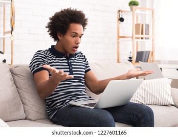 Shocked Teen Guy Having Problem In Laptop At Home, Copy Space