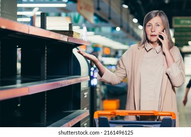 Shocked And Upset Senior Woman In A Supermarket Near Empty Shelves, No Goods