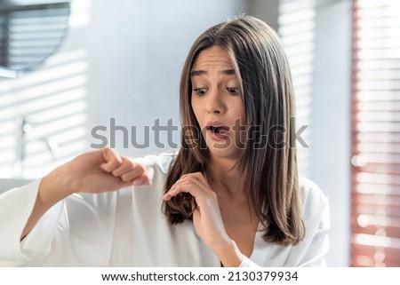 Shocked Upset Woman Looking At Her Dry Brittle Hair While Standing In Bathroom At Home, Terrified Young Female Worried About Hairloss, Suffering Iron Deficiency And Health Problem, Copy Space Foto stock © 