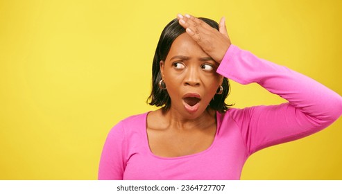 Shocked and upset young woman puts hands to head, yellow studio background - Shutterstock ID 2364727707