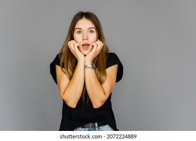 Shocked woman covers her mouth with hands, isolated on white background - Shutterstock ID 2072224889