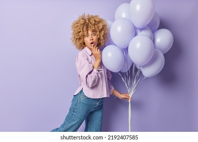 Shocked Woman With Curly Hair Feels Impressed Cannot Believe In Unexpected Amazing News Dressed In Stylish Outfit Holds Bunch Of Inflated Balloons Celebrates Something Prepares For Gender Party