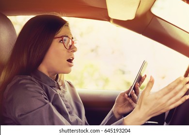 Shocked Woman Distracted By Mobile Phone Texting While Driving A Car 