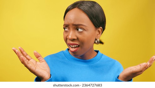 Shocked woman holds palms up in disbelief, yellow studio background - Shutterstock ID 2364727683