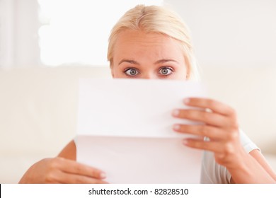 Shocked Woman Reading A Letter In Her Living Room